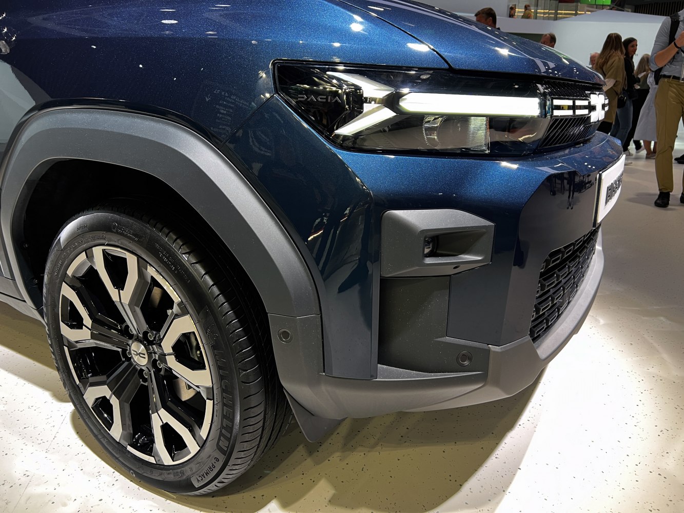 Close-up of front LED headlight and alloy wheel on SUV