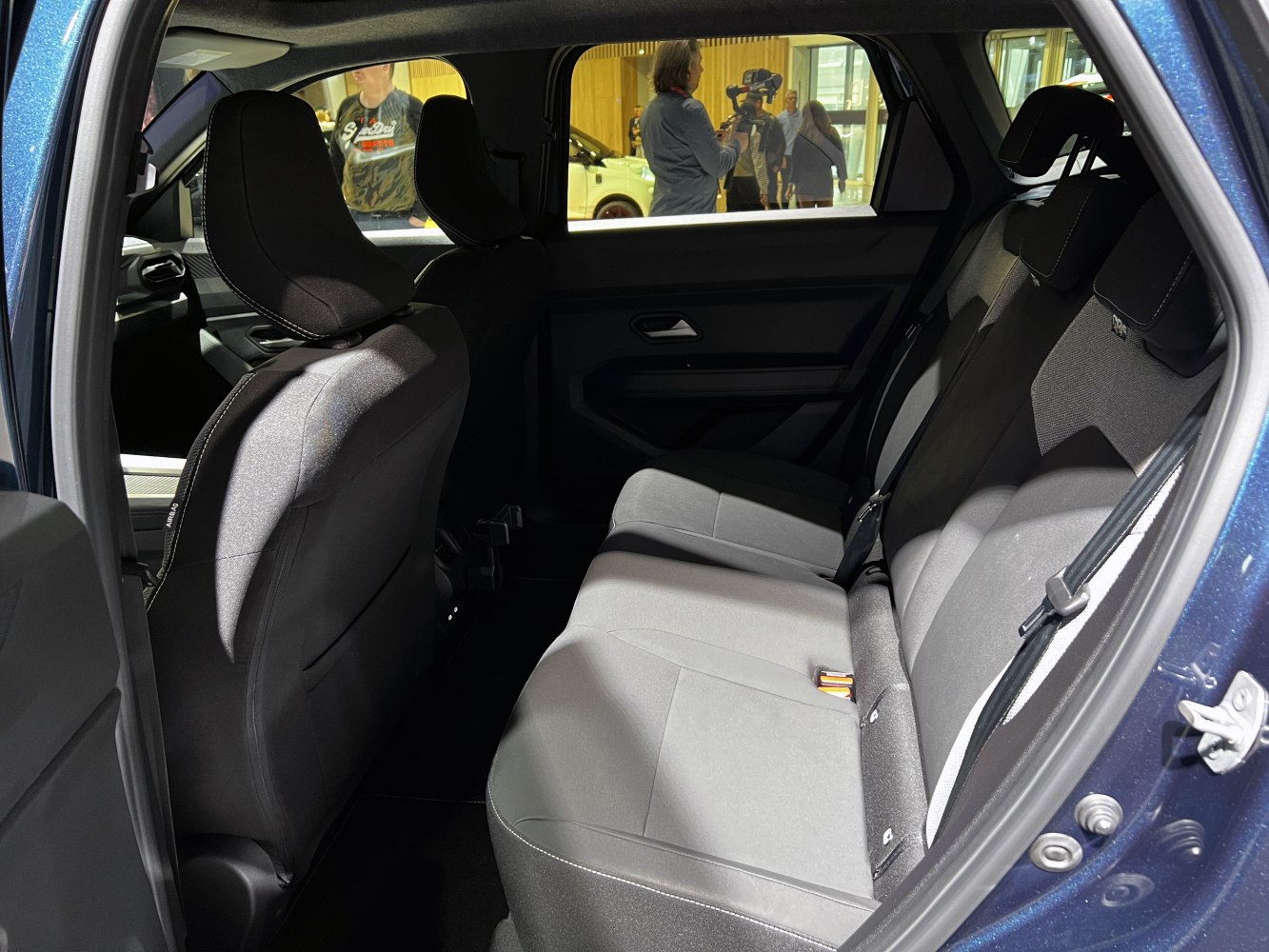 Rear passenger seats with fabric upholstery and ergonomic design.