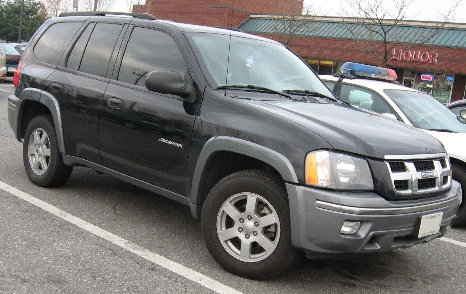 Black mid-size SUV with front grille and alloy wheels