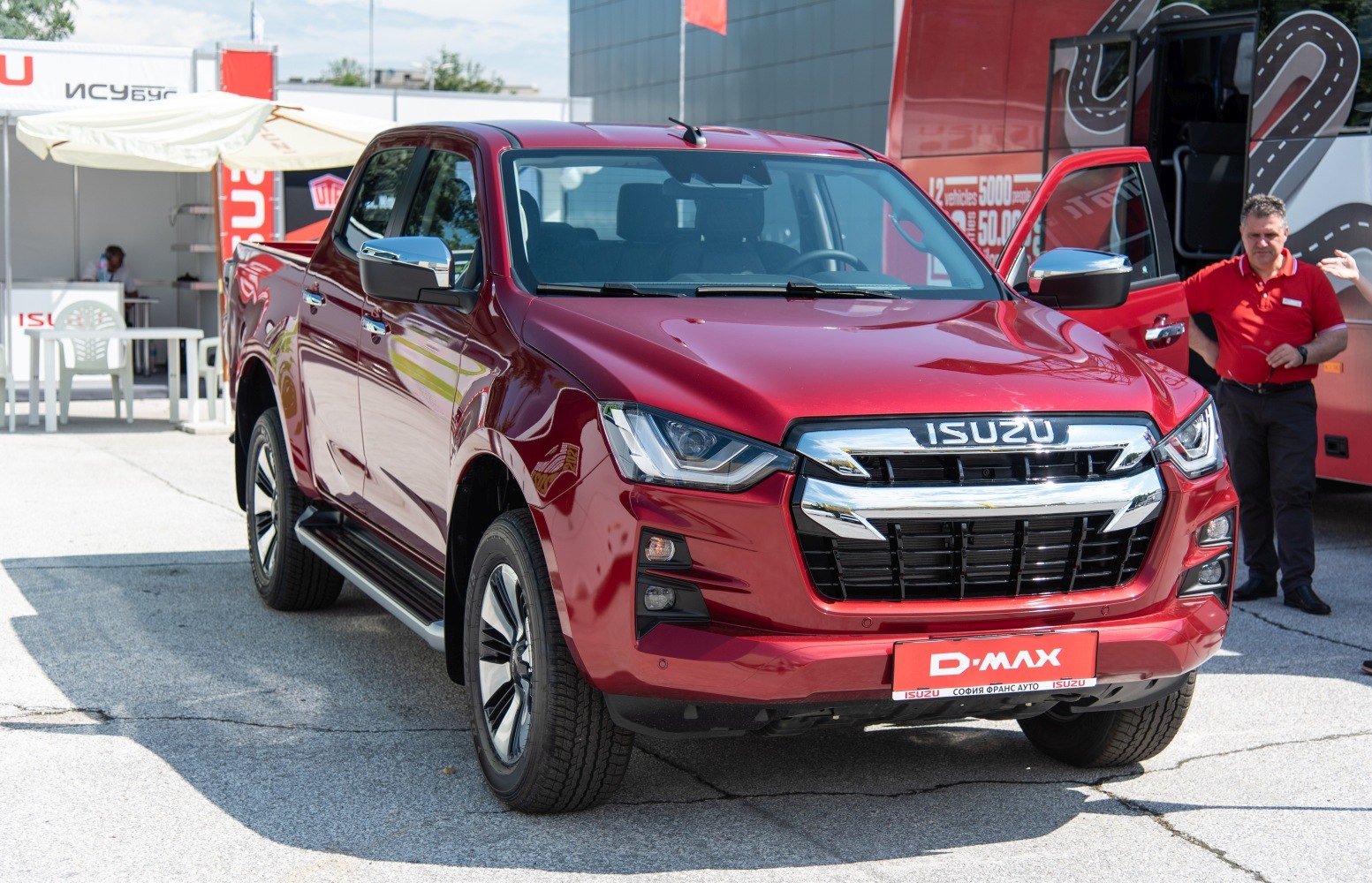 Red pickup truck front with chrome grille and LED headlights