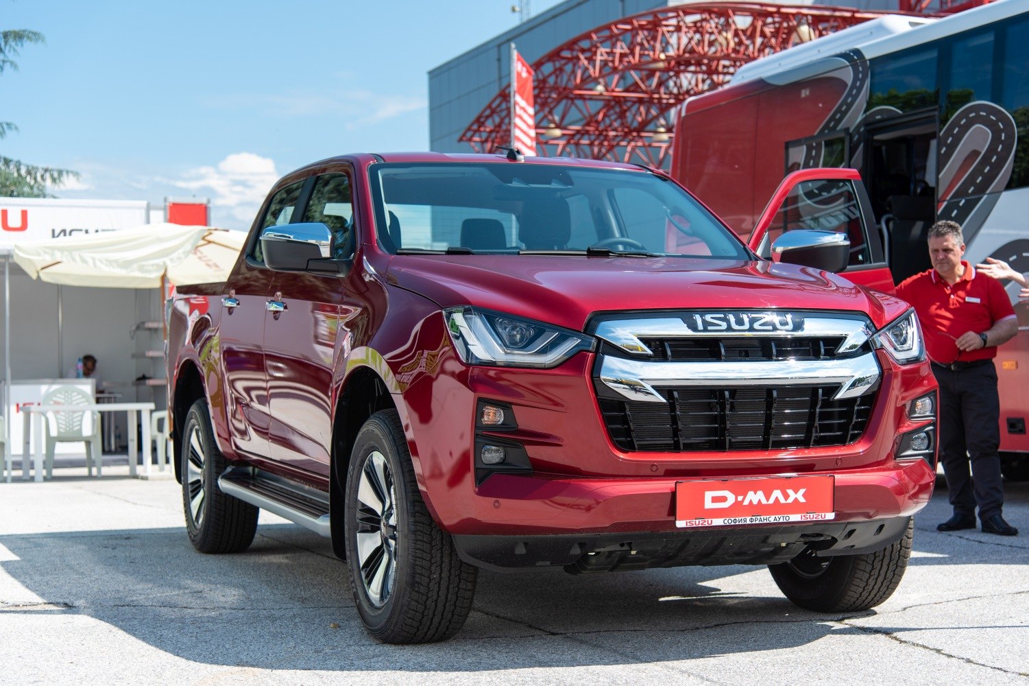 Red pickup with bold front grille and modern headlights