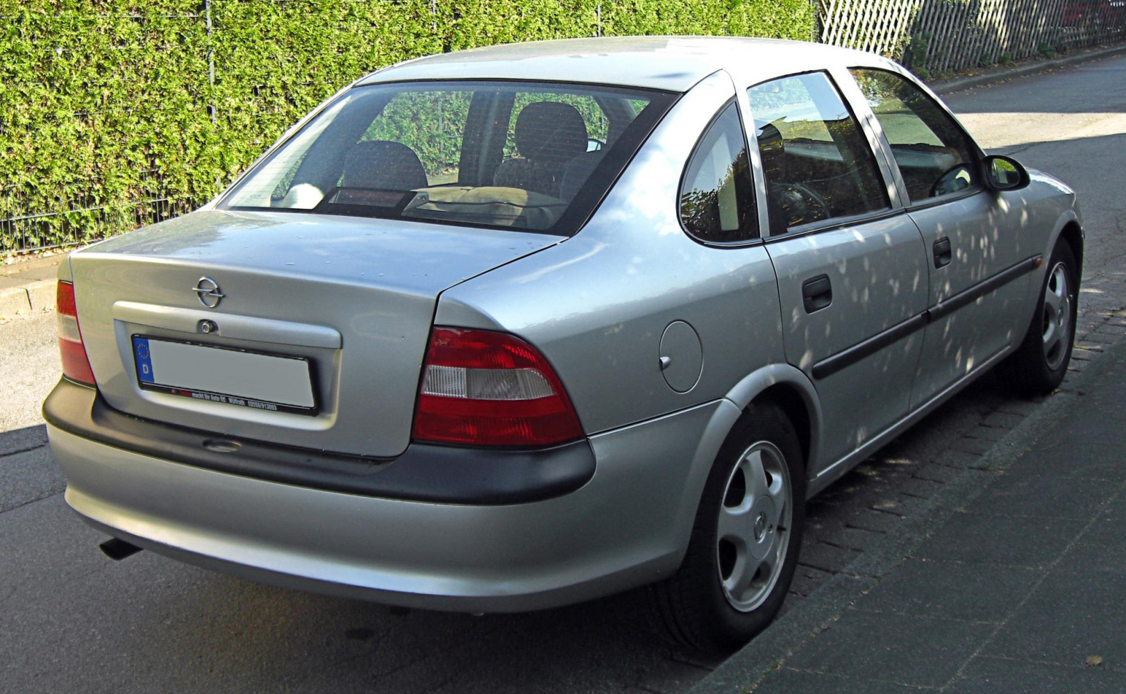 Rear view of a mid-90s sedan showing tail lights and trunk design