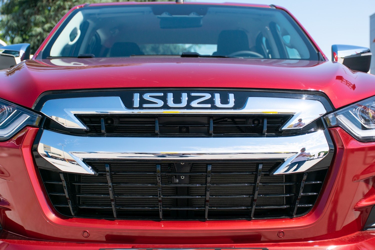 Chrome-accented front grille and bold emblem on pickup truck front