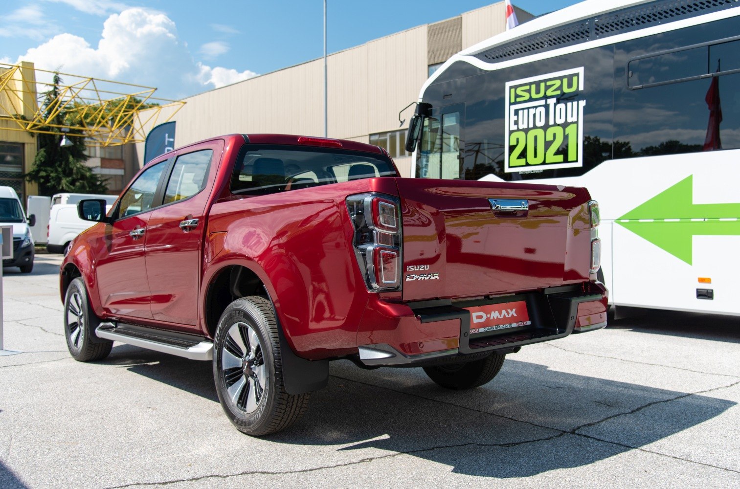 Rear view of a red double cab pickup with distinct taillights and tailgate.
