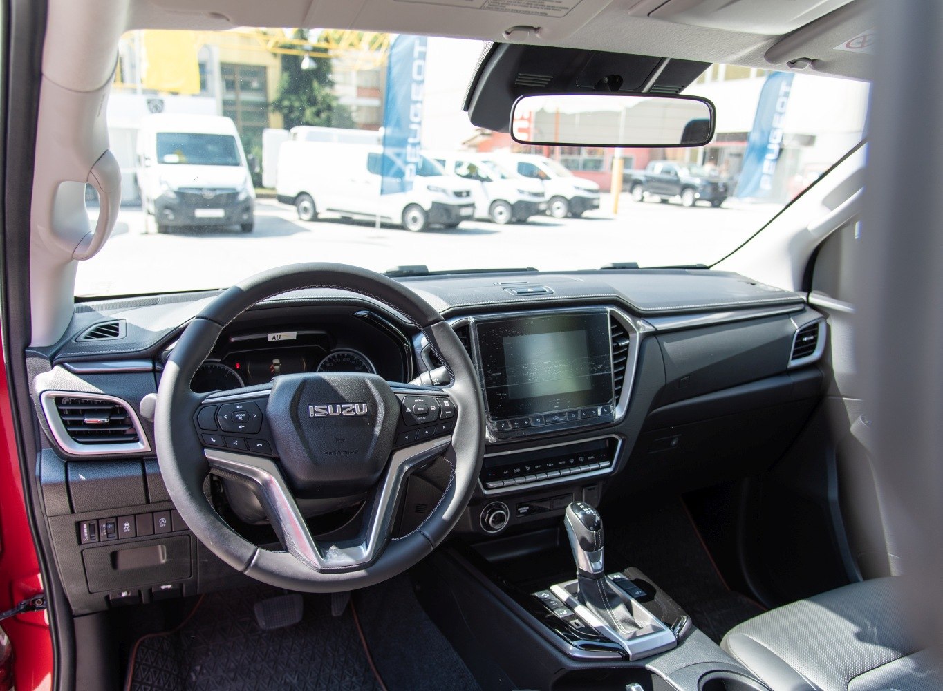 Steering wheel and dashboard with touchscreen and automatic transmission.