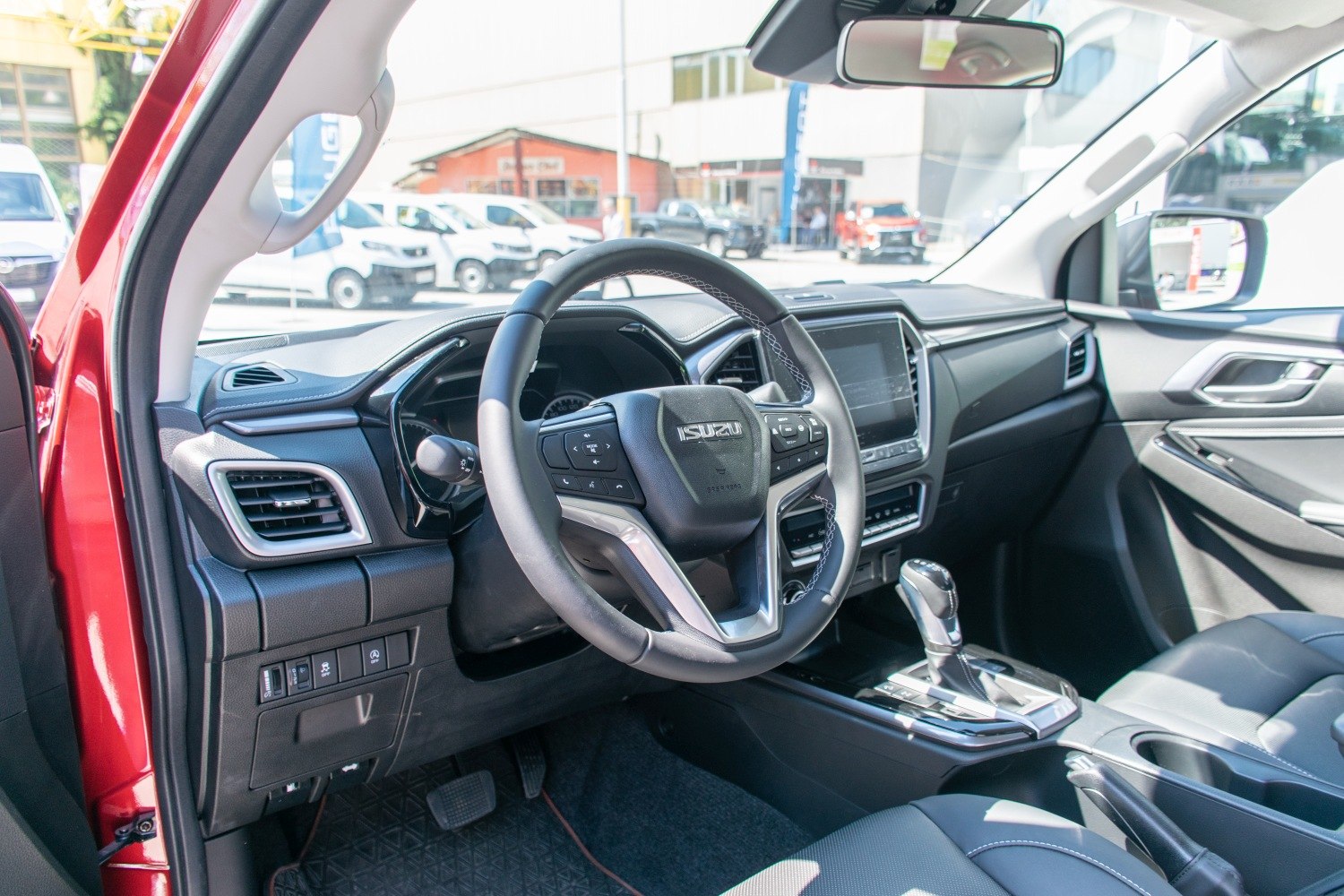Steering wheel with controls and gear shift lever in vehicle interior