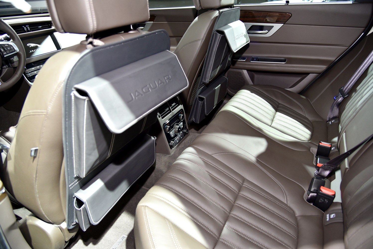 Spacious rear seat with dual-tone leather upholstery and rear climate control panel.