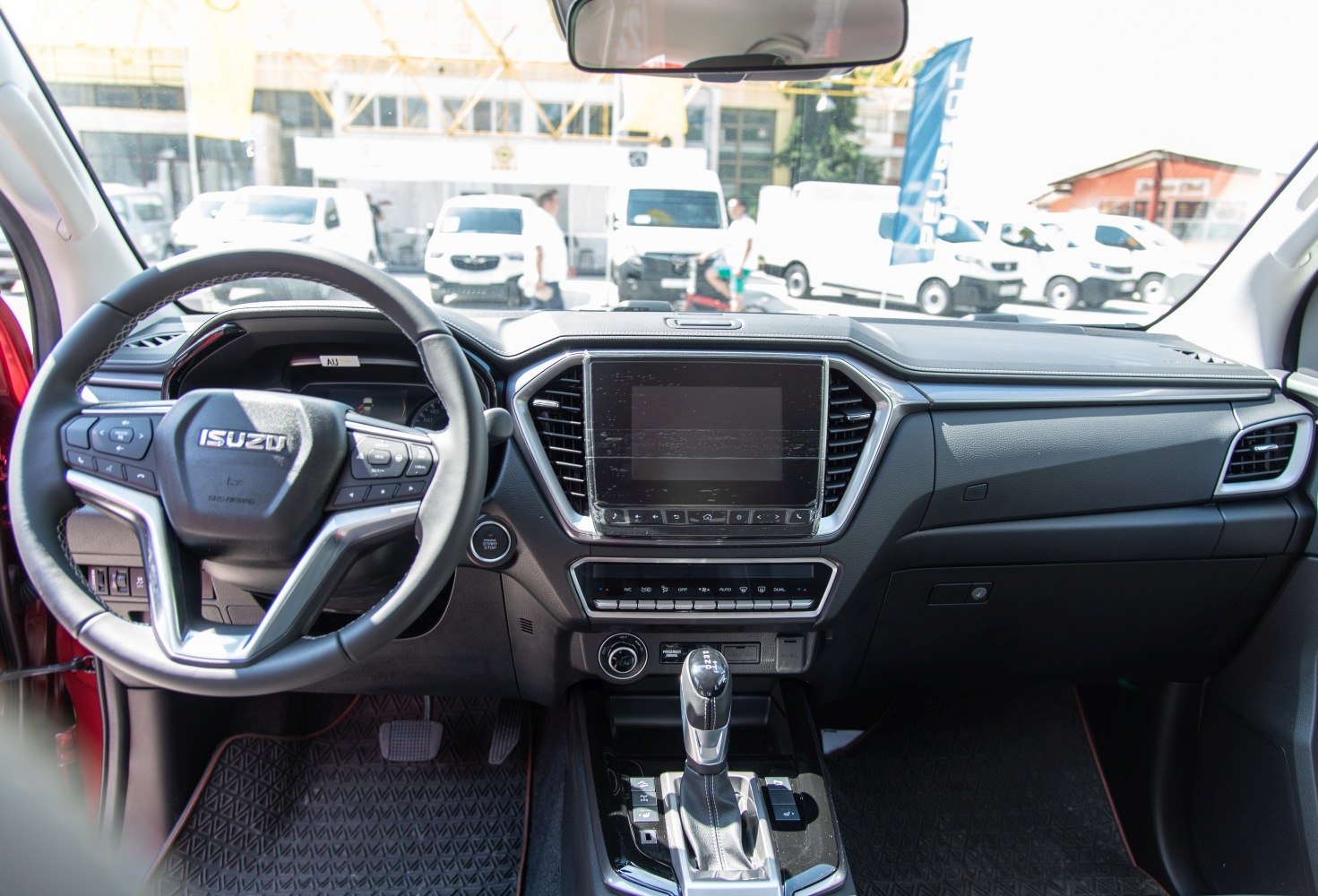 Modern interior dashboard with touchscreen and multifunction steering wheel.