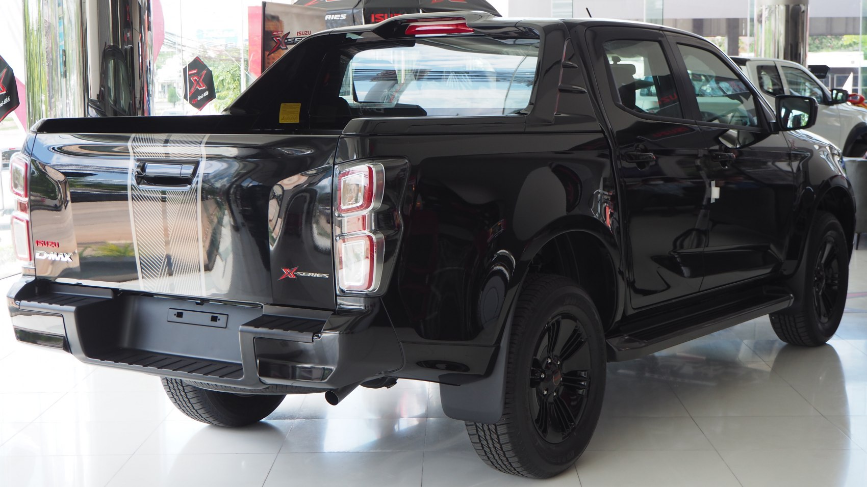 Black double cab pickup rear with distinctive taillights and sporty bed cover