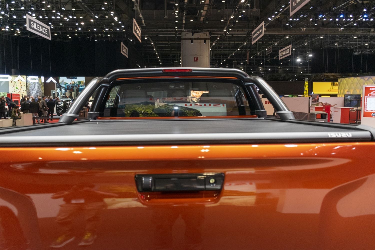 Rear view of double cab pickup with tonneau cover and metallic roll bars
