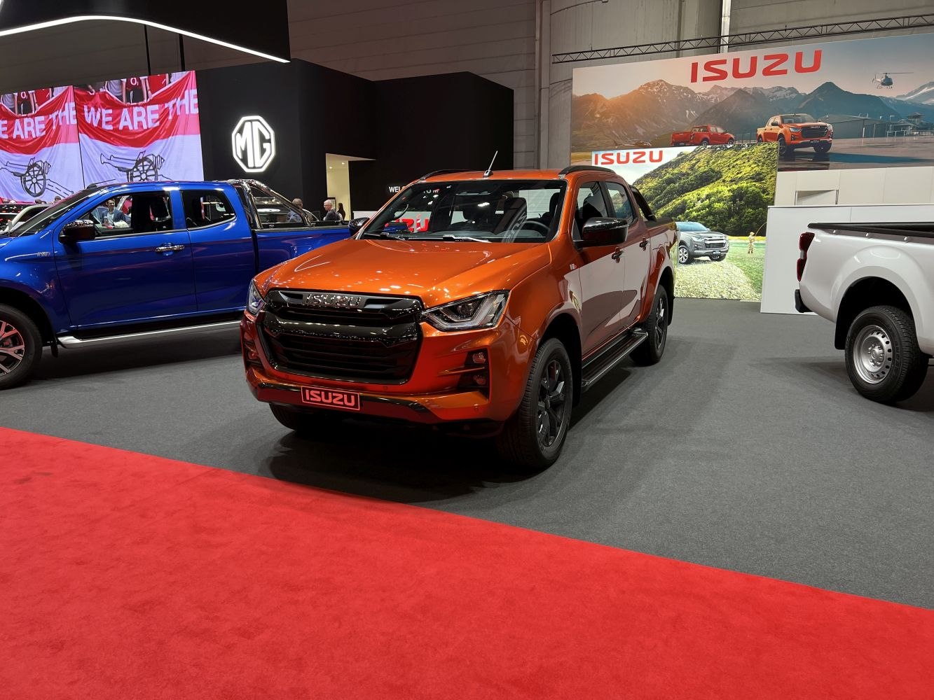 Orange pickup truck with double cab and black alloy wheels