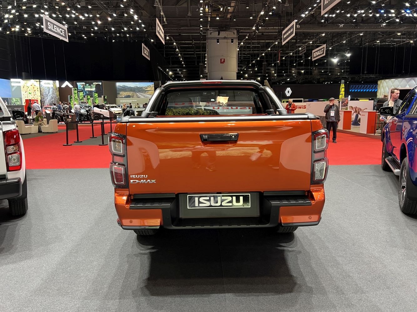Bright orange pickup tailgate with distinct taillight design.