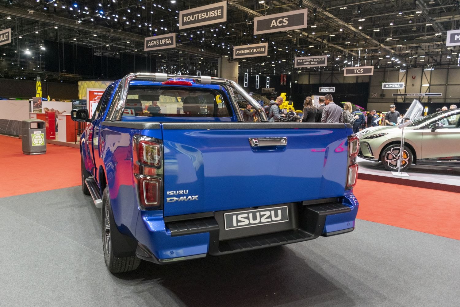 Rear view of a blue pickup truck with tailgate and taillights