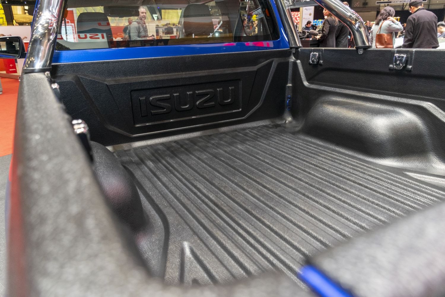 Textured durable truck bed liner with embossed branding