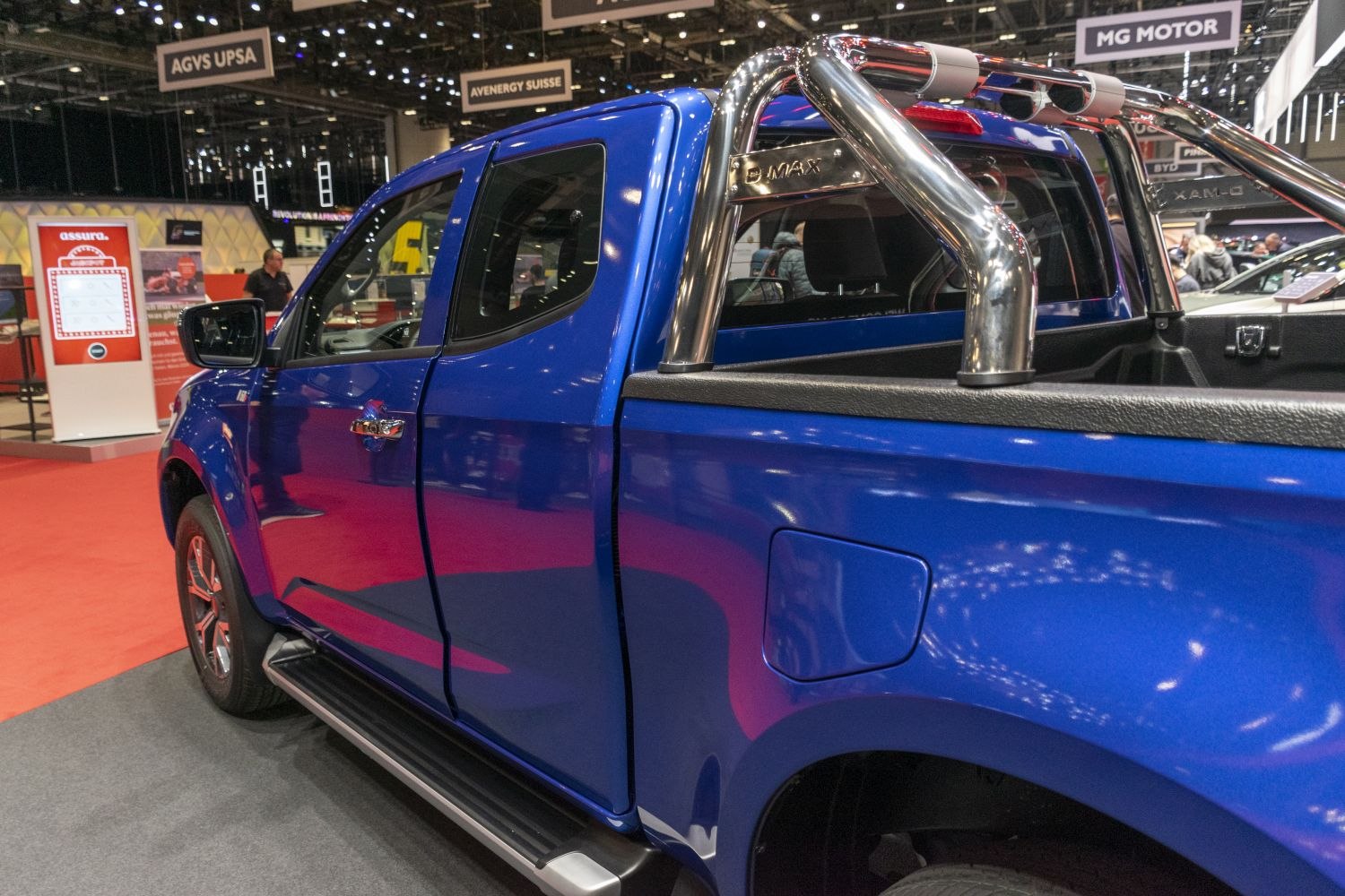 Blue pick-up truck side with chrome roll bar and side step