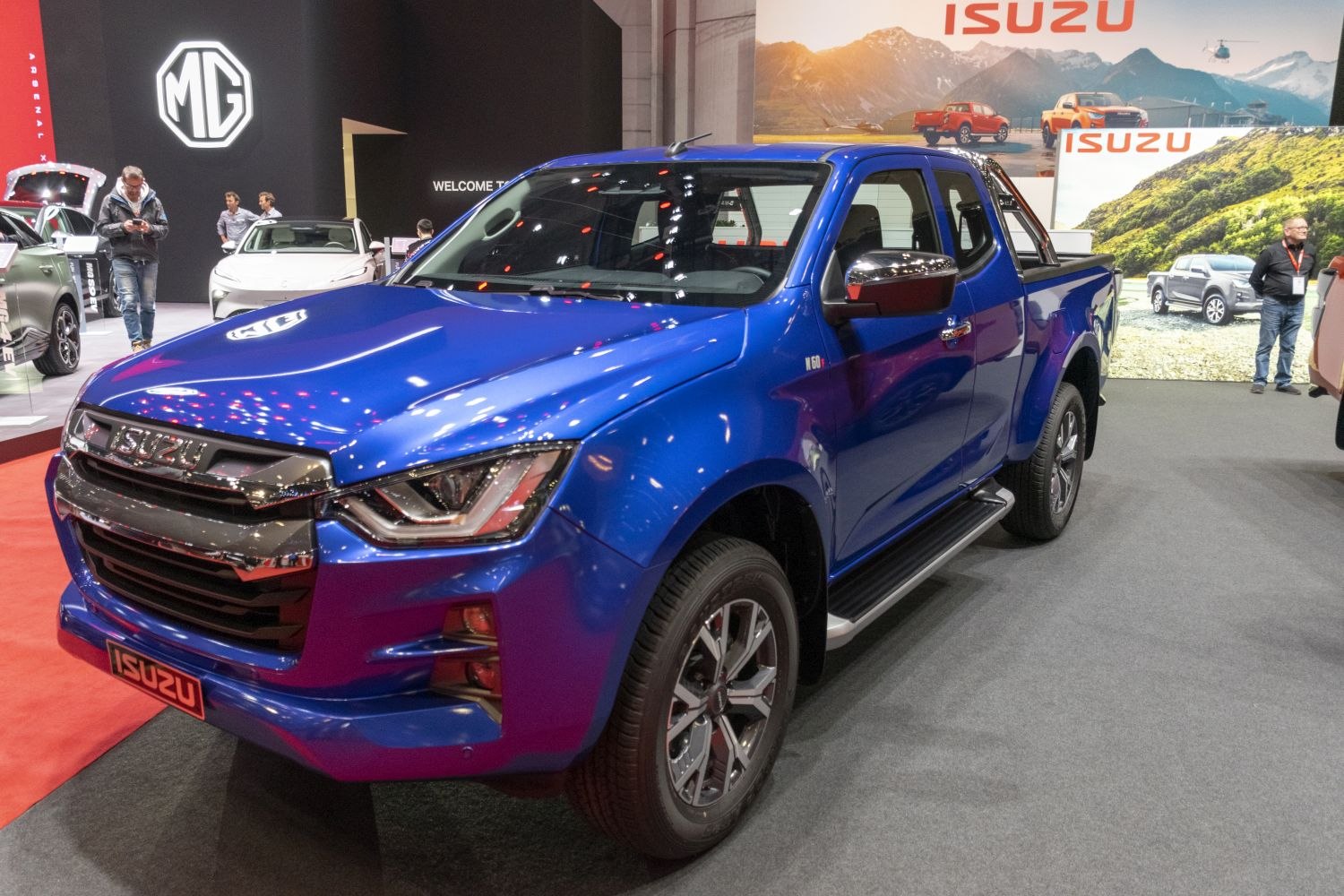 Blue pickup truck with bold grille and dual cab design