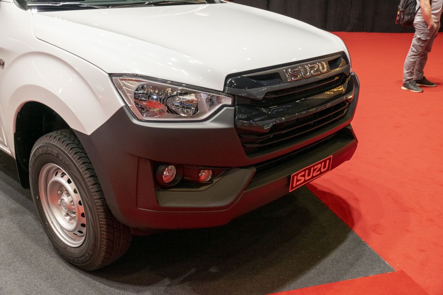 Close-up of front fascia with headlight and black grille