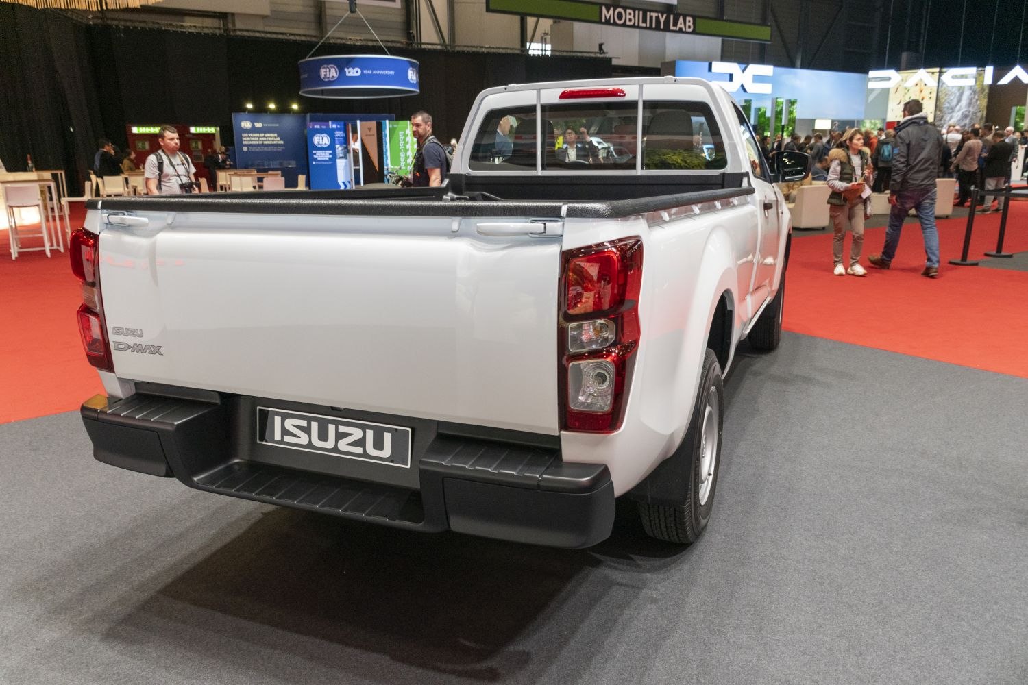 Rear view of a white pickup truck with distinct taillights and pickup bed