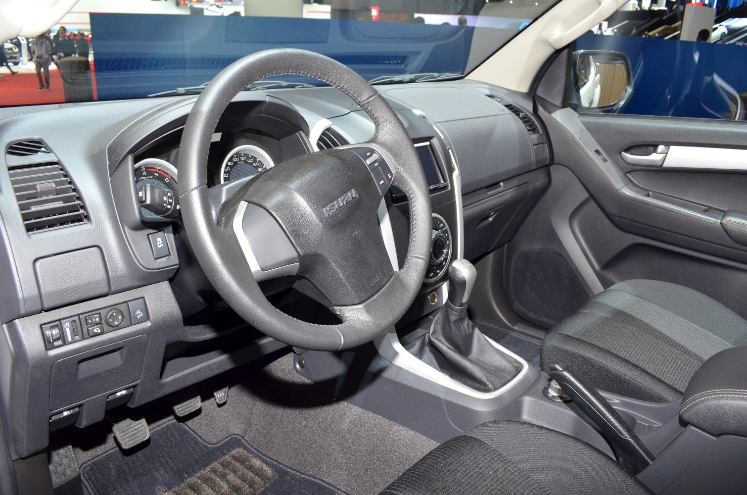 Steering wheel, dashboard, manual gear shift, and driver-side controls.