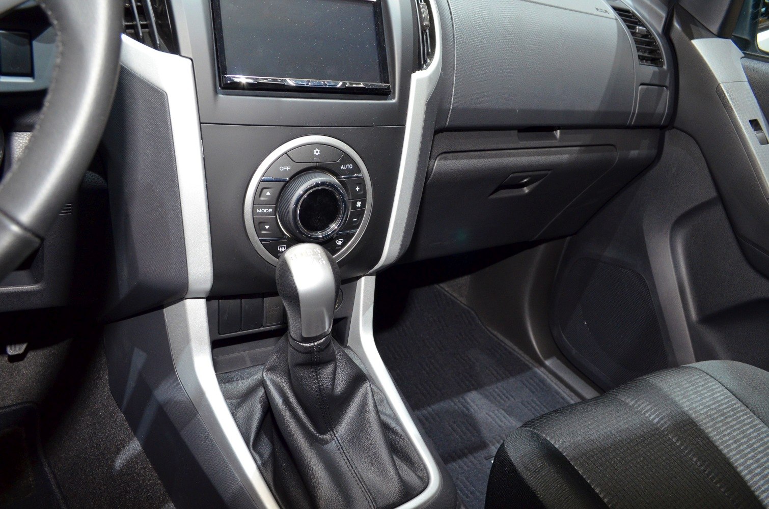 Manual gear shift and climate control dial in vehicle interior