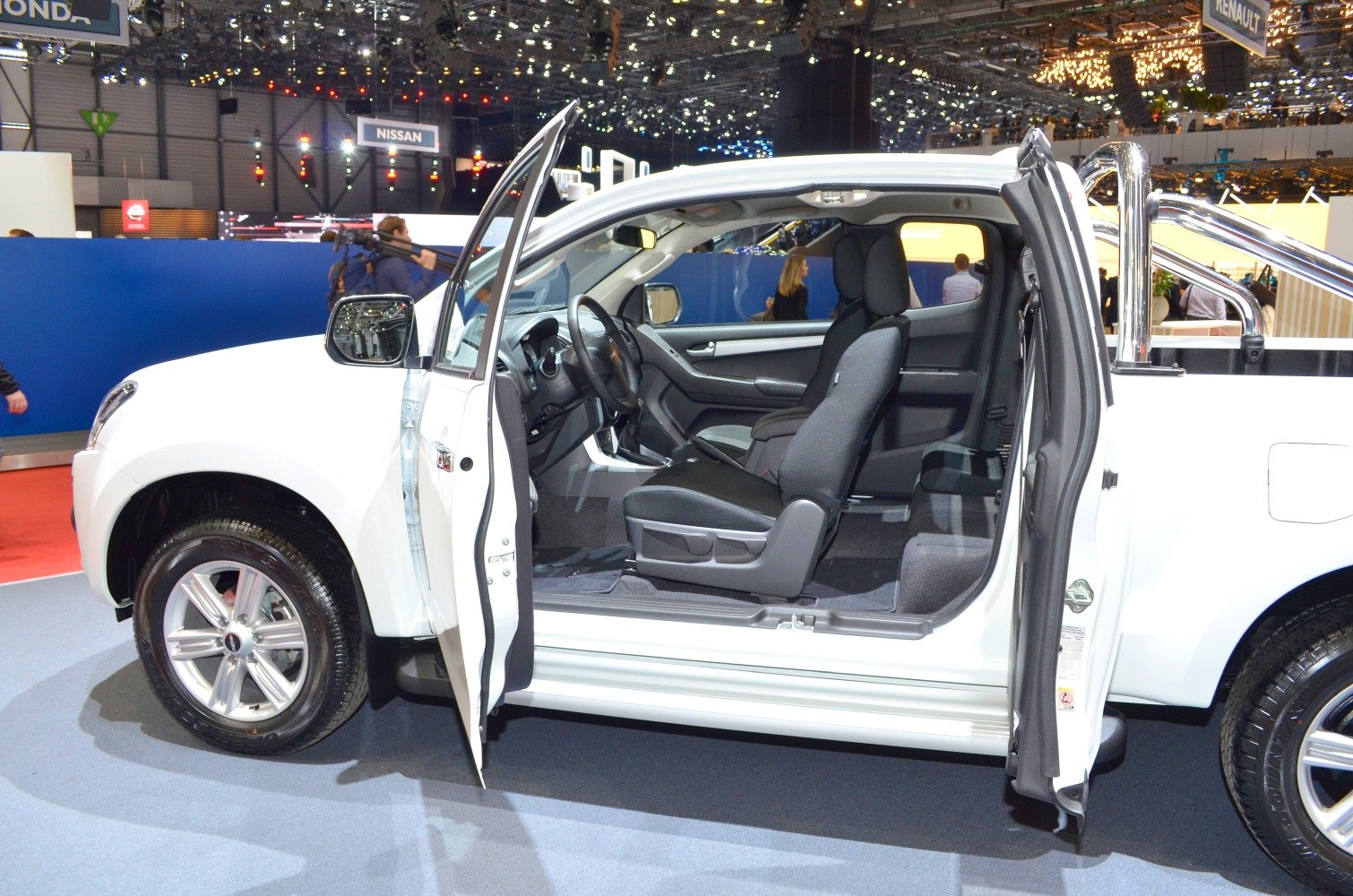 Pickup interior and side view with open doors revealing seats and cabin.