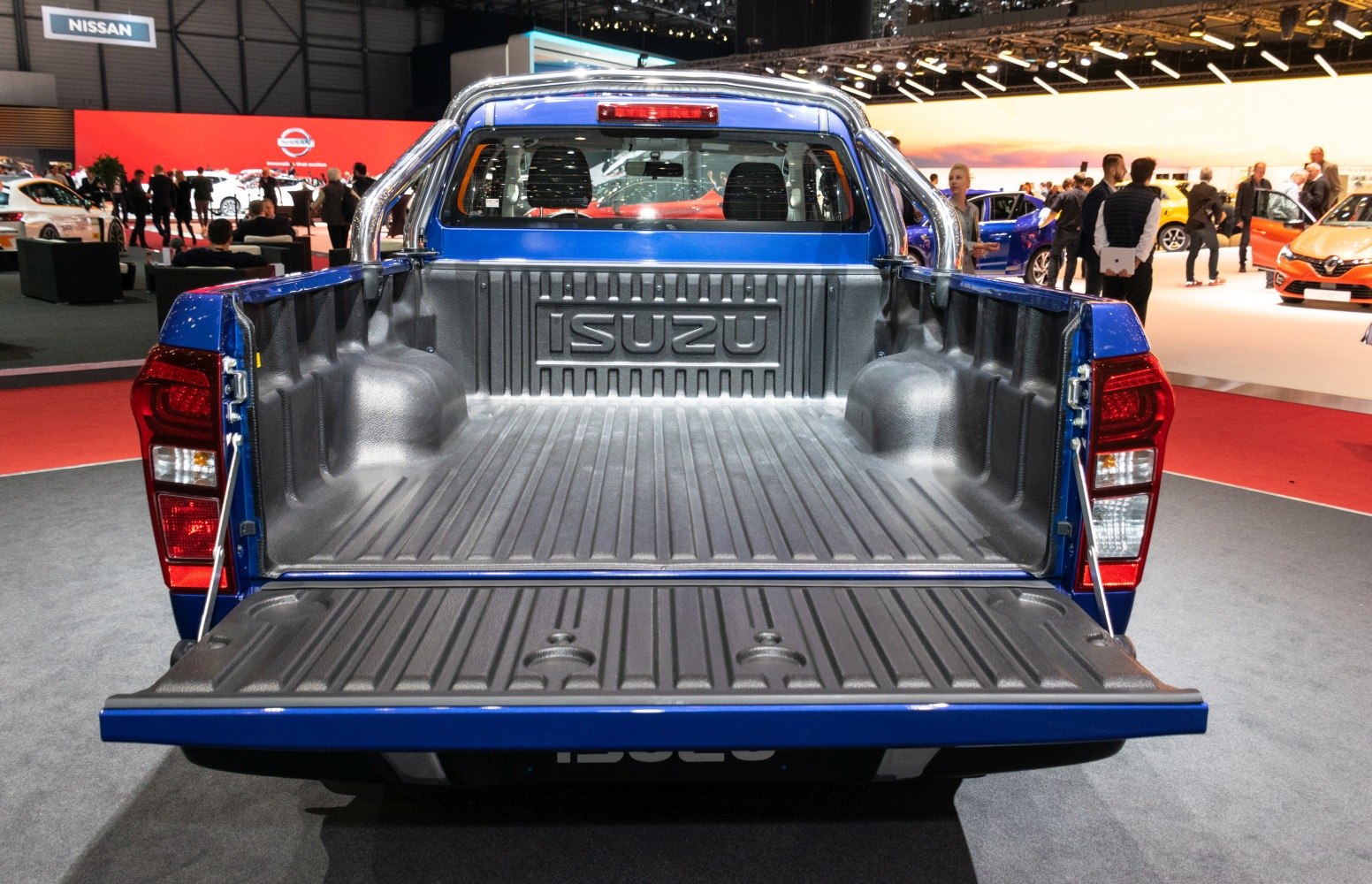 Spacious pickup truck bed with protective liner and open tailgate.