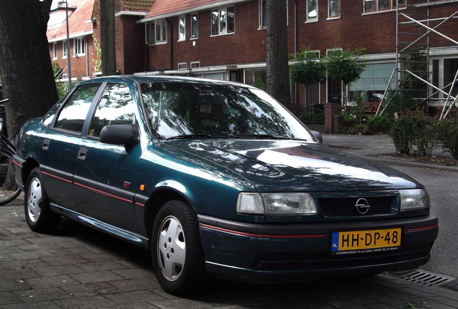 Front side view of mid-90s four-door sedan with classic design elements.