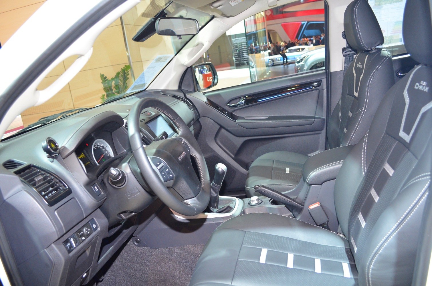 Leather seats and dashboard layout with steering wheel and manual gear shift