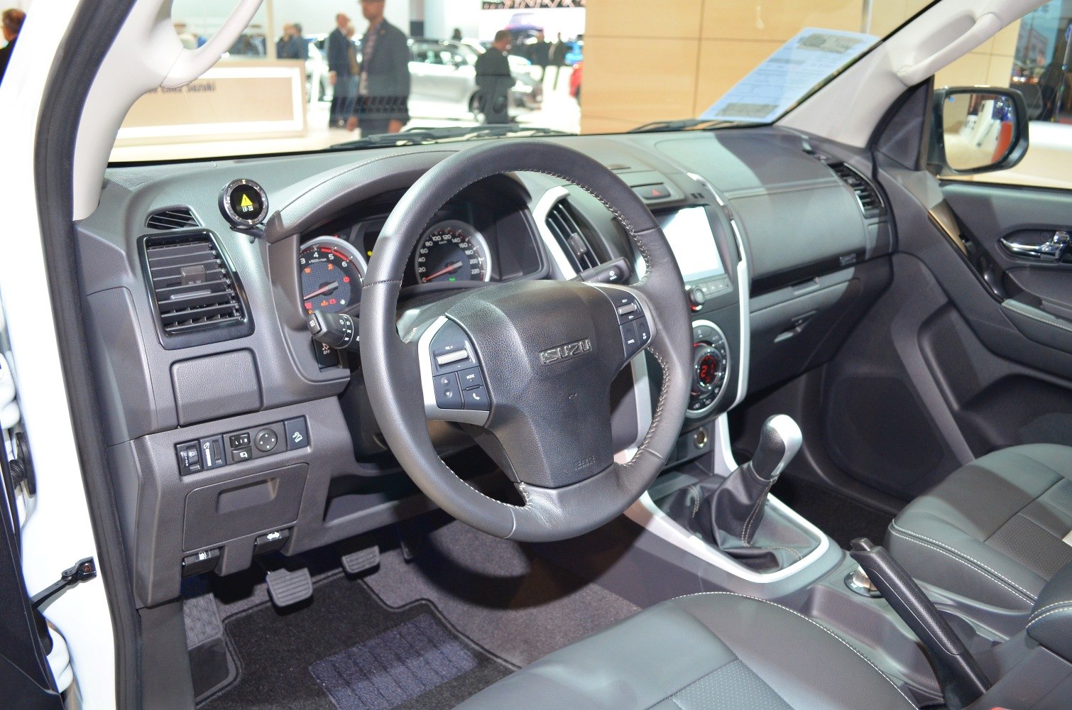 Steering wheel, manual gear shift, dashboard, and seats interior view