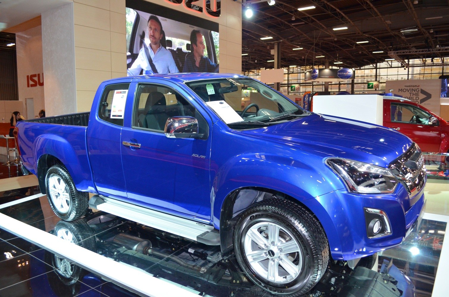 Blue mid-size pickup truck with alloy wheels and chrome mirrors