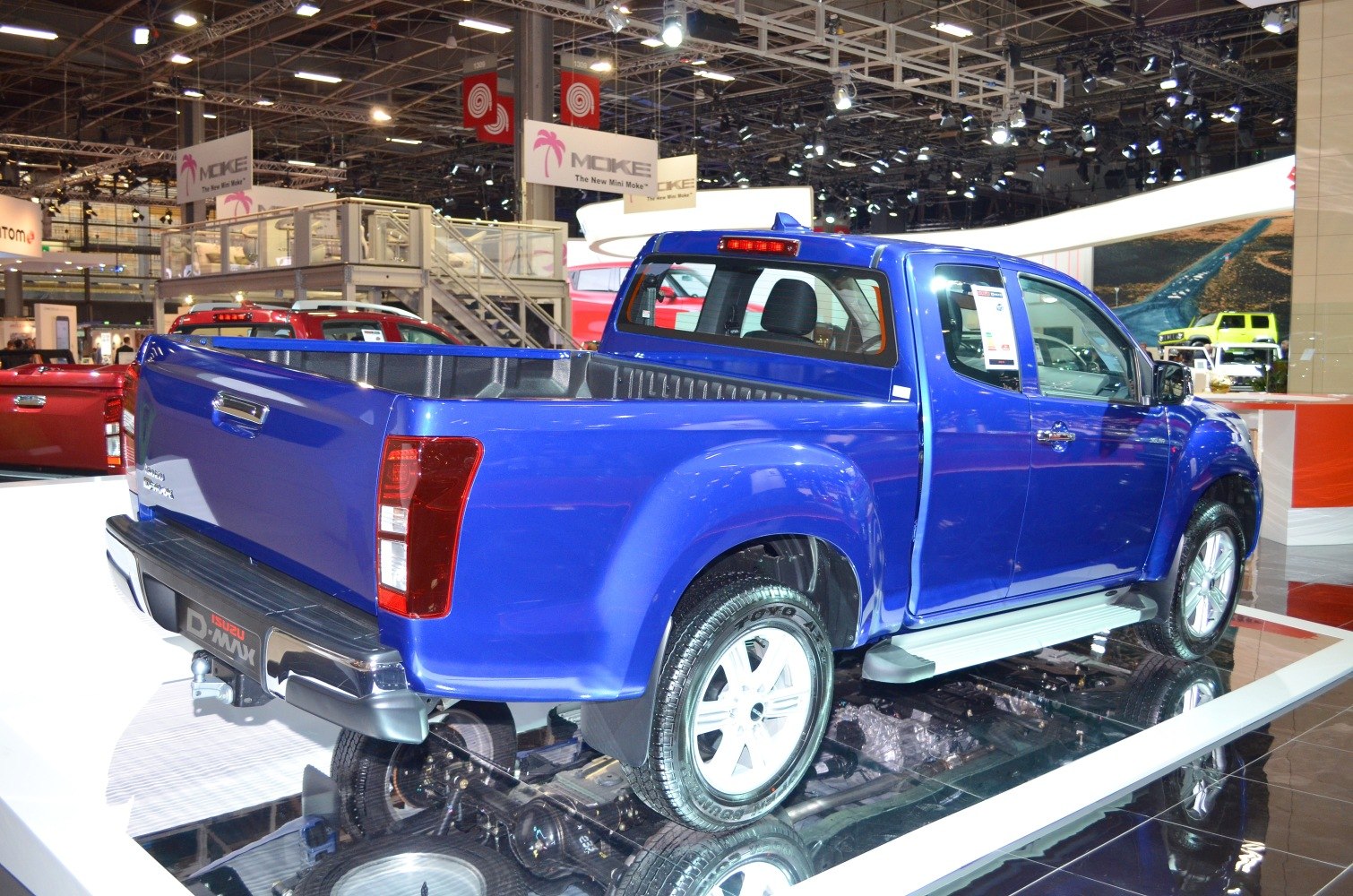 Rear and side view of blue pickup with cargo bed and modern wheels
