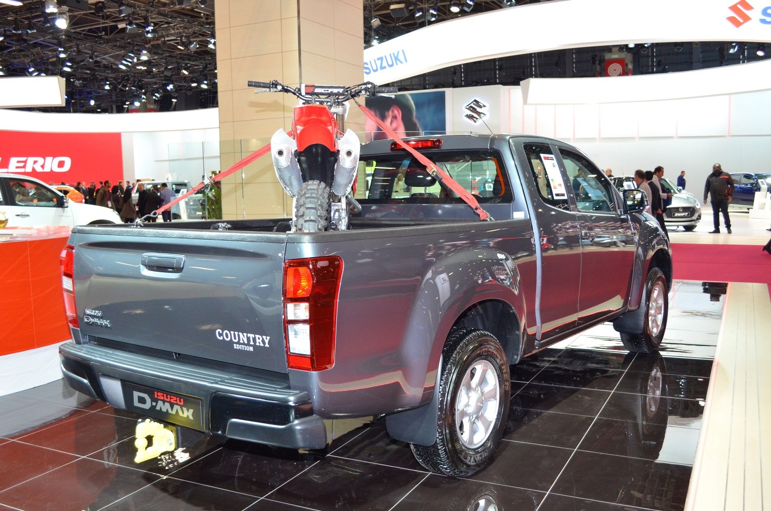 Rear and side view of pickup with dirt bike secured in bed