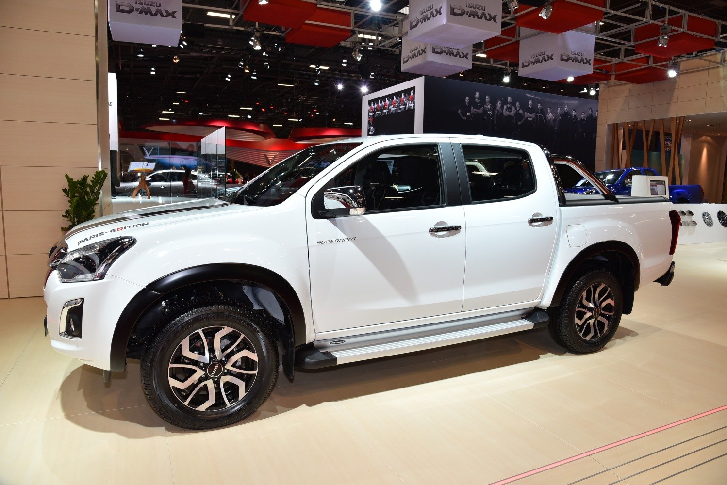 White pickup with alloy wheels and black trim in side profile