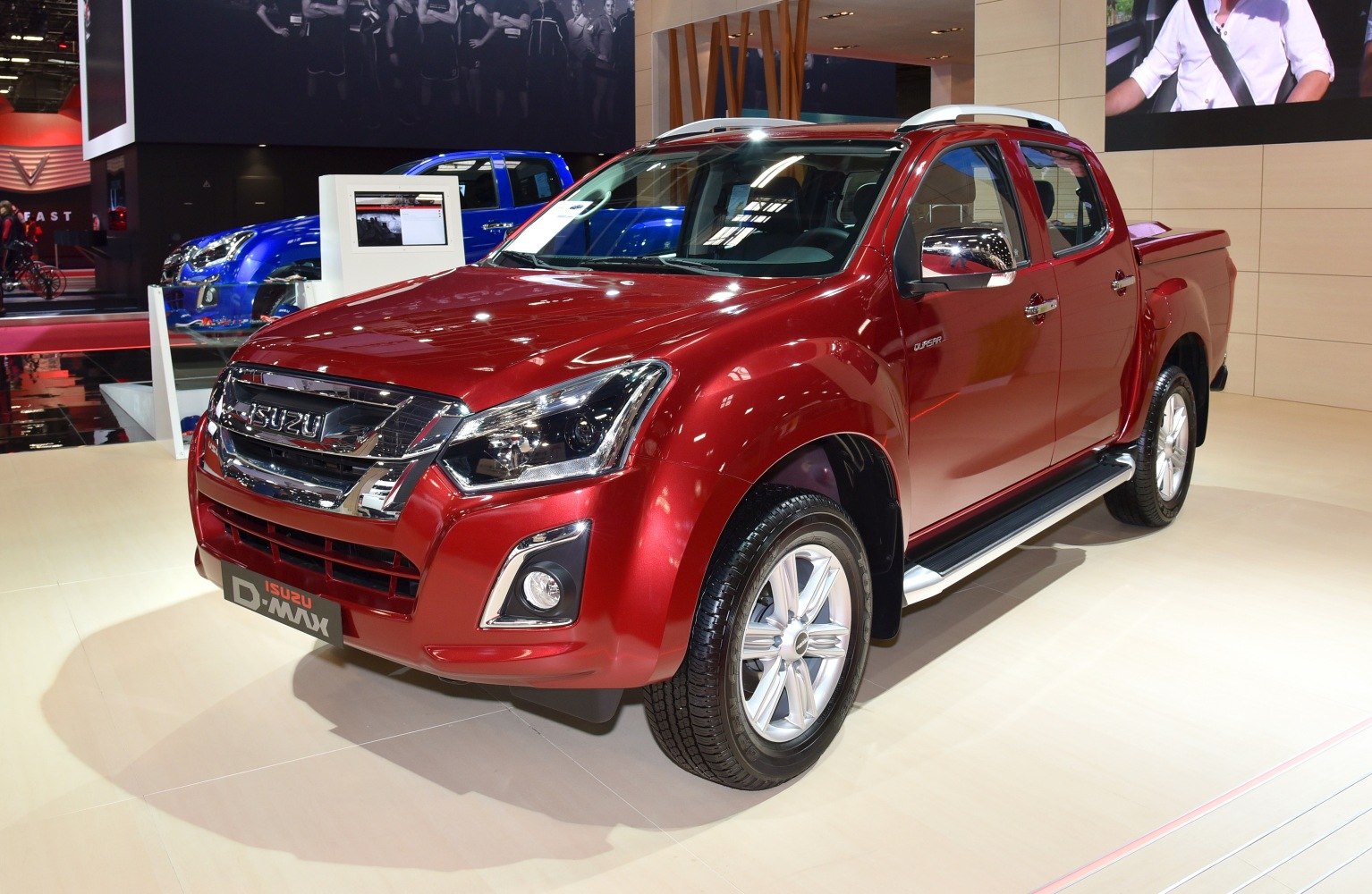 Red double cab pickup truck with modern front design and alloy wheels