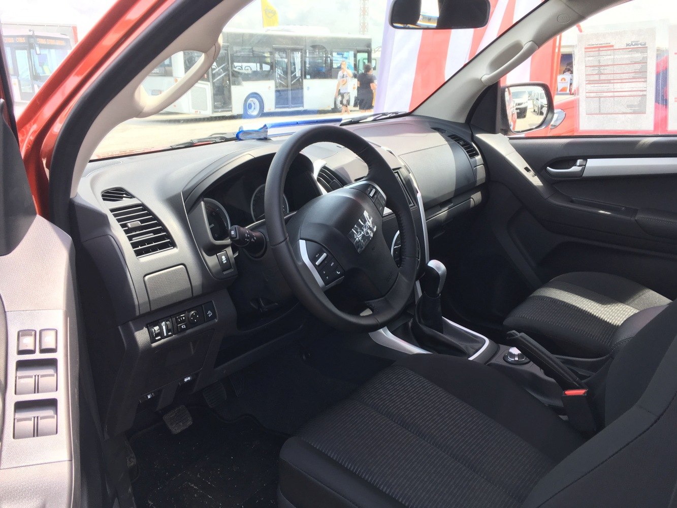 Steering wheel, gear shift, dashboard controls, and front seats