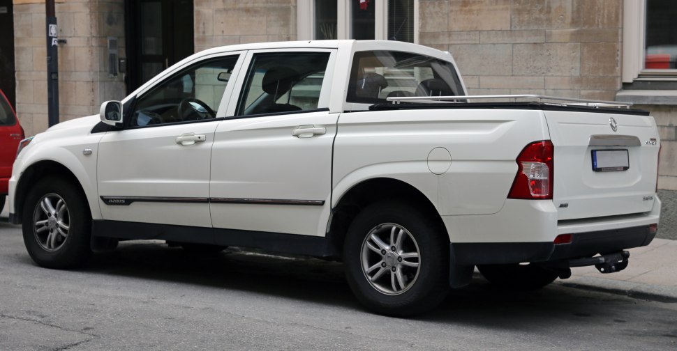 White double cab pickup truck with covered cargo bed and alloy wheels