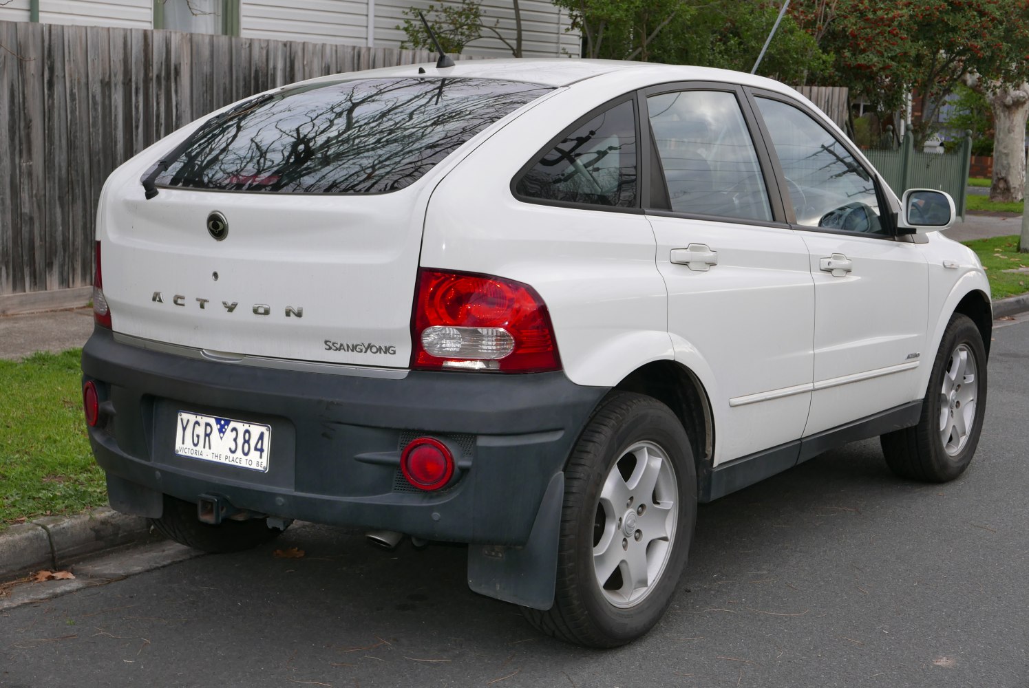 Rear side view with tail lights and distinct bumper of a white hatchback.
