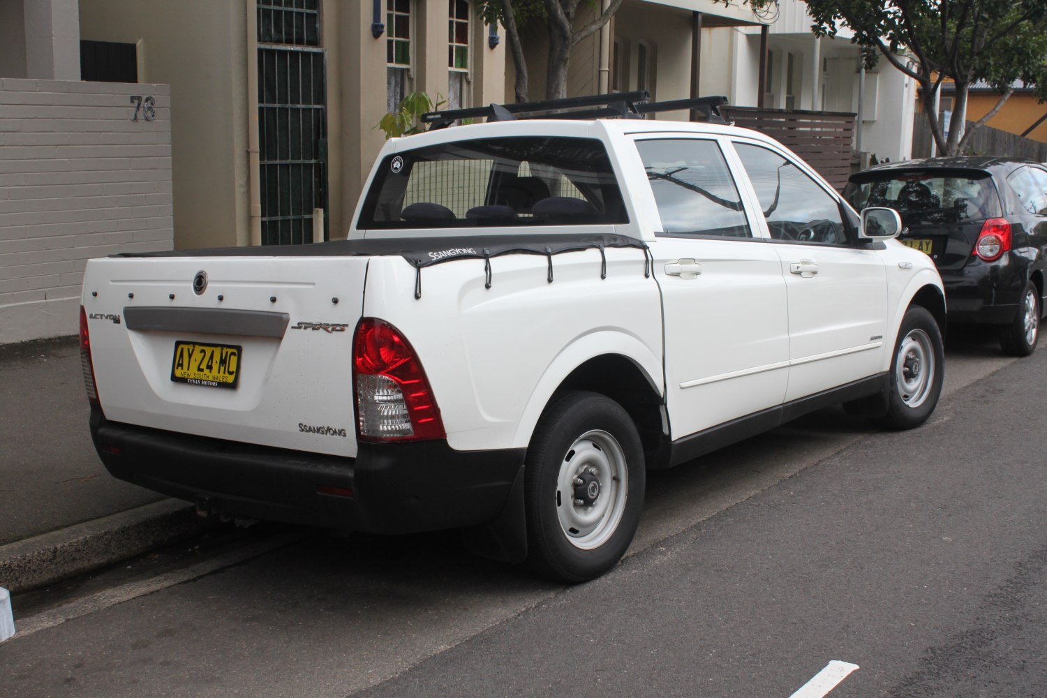 White pickup truck with covered cargo bed and steel wheels
