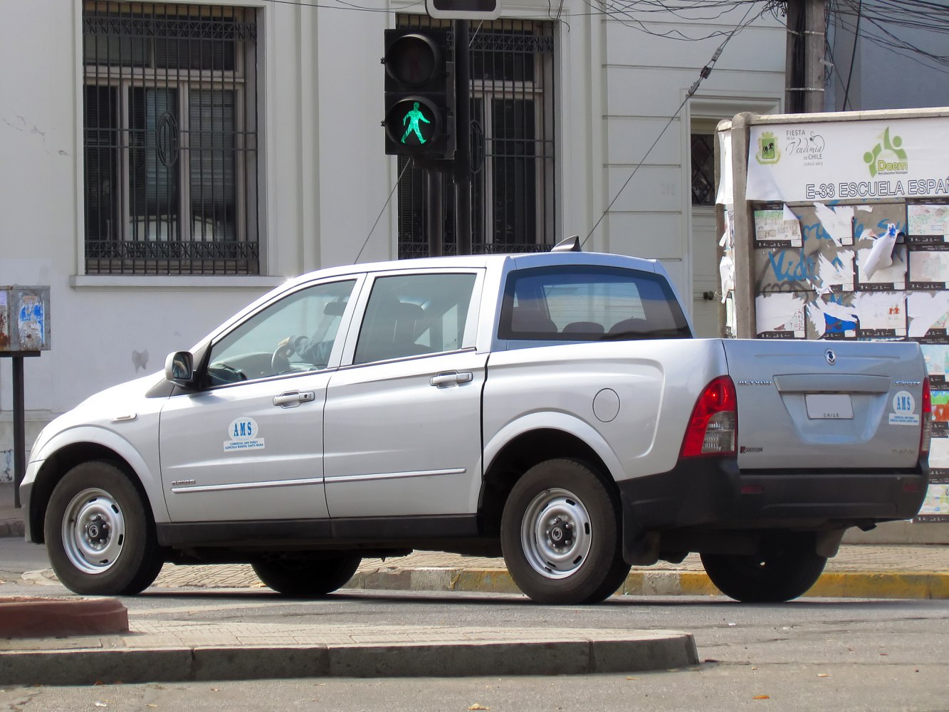 Silver double cab pickup with steel wheels from rear side
