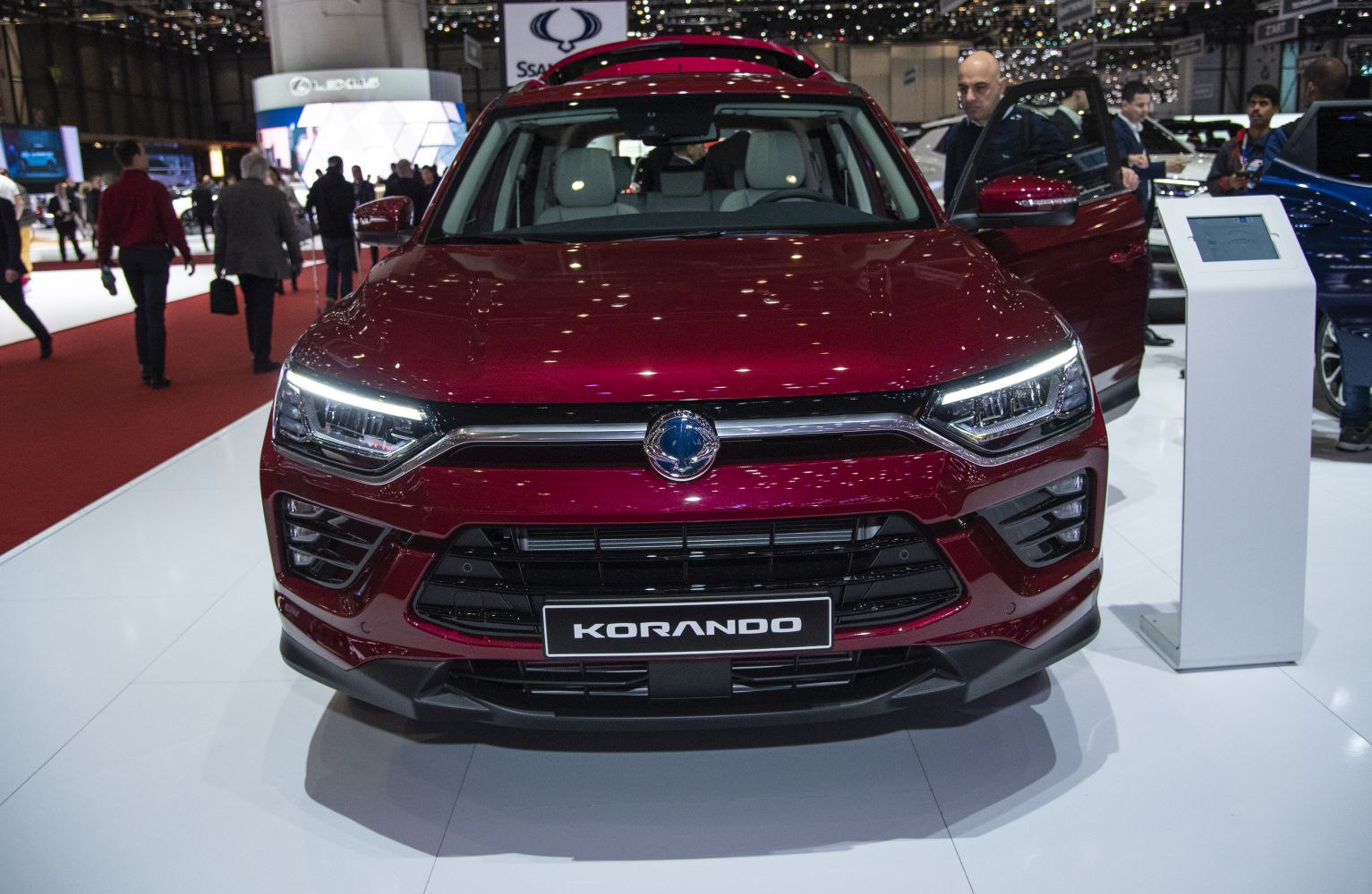Front view of red SUV with LED headlights and distinctive grille.
