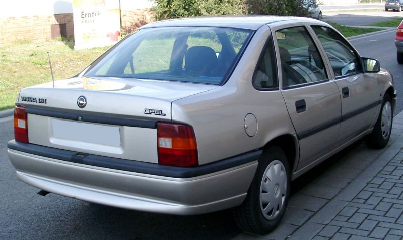 Rear view of a 1992 sedan with distinct taillights, trunk, and rear bumper.