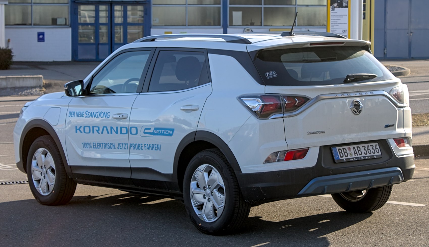 Rear side view of electric SUV with taillights and aerodynamic wheel covers