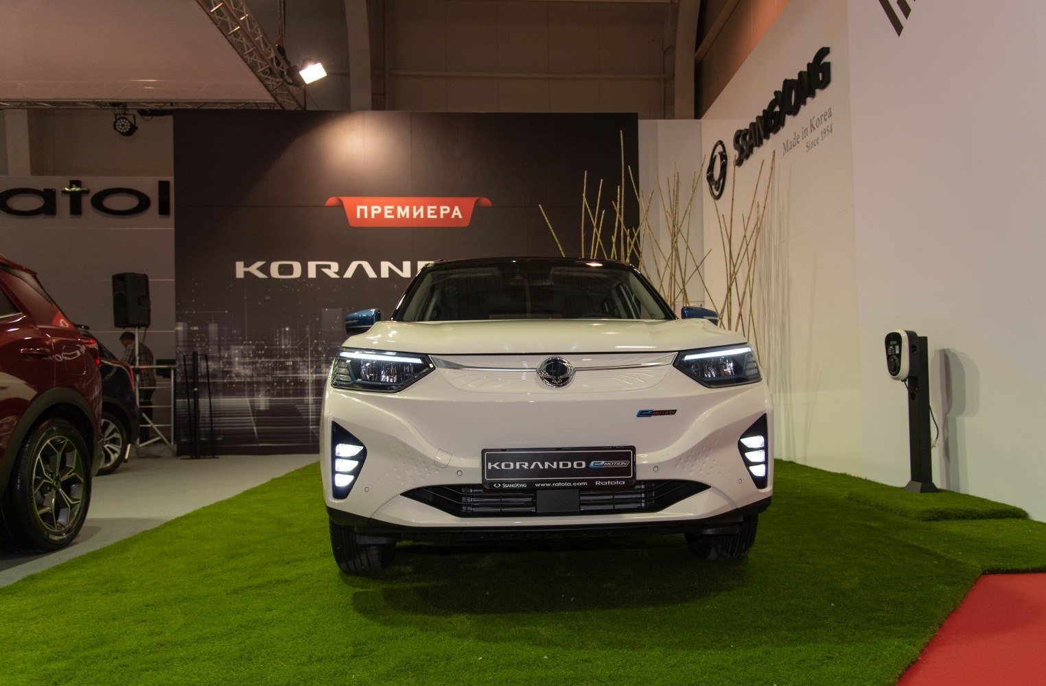 Front view with LED headlights and modern bumper of electric SUV