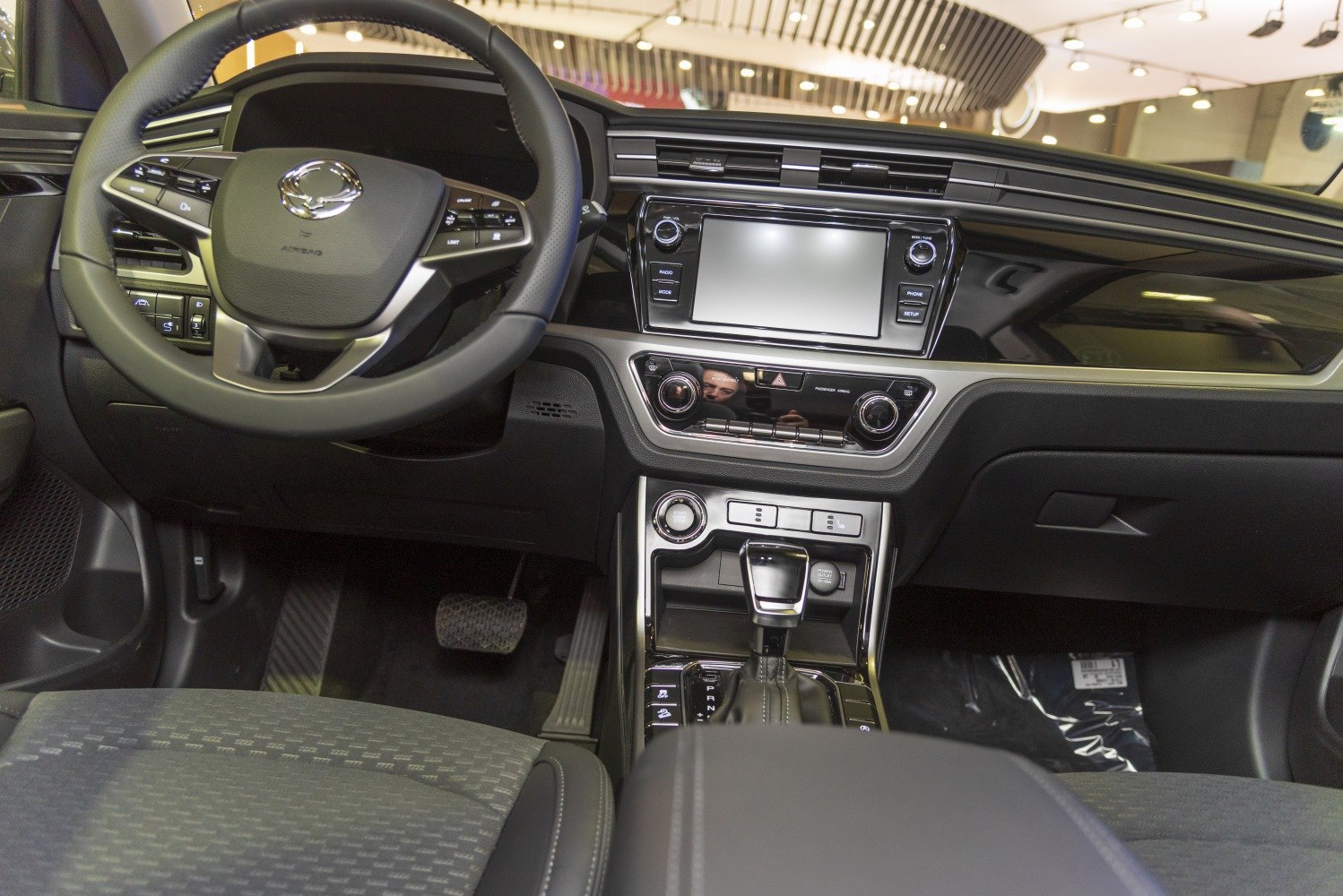 Modern car interior with dashboard and multifunction steering wheel