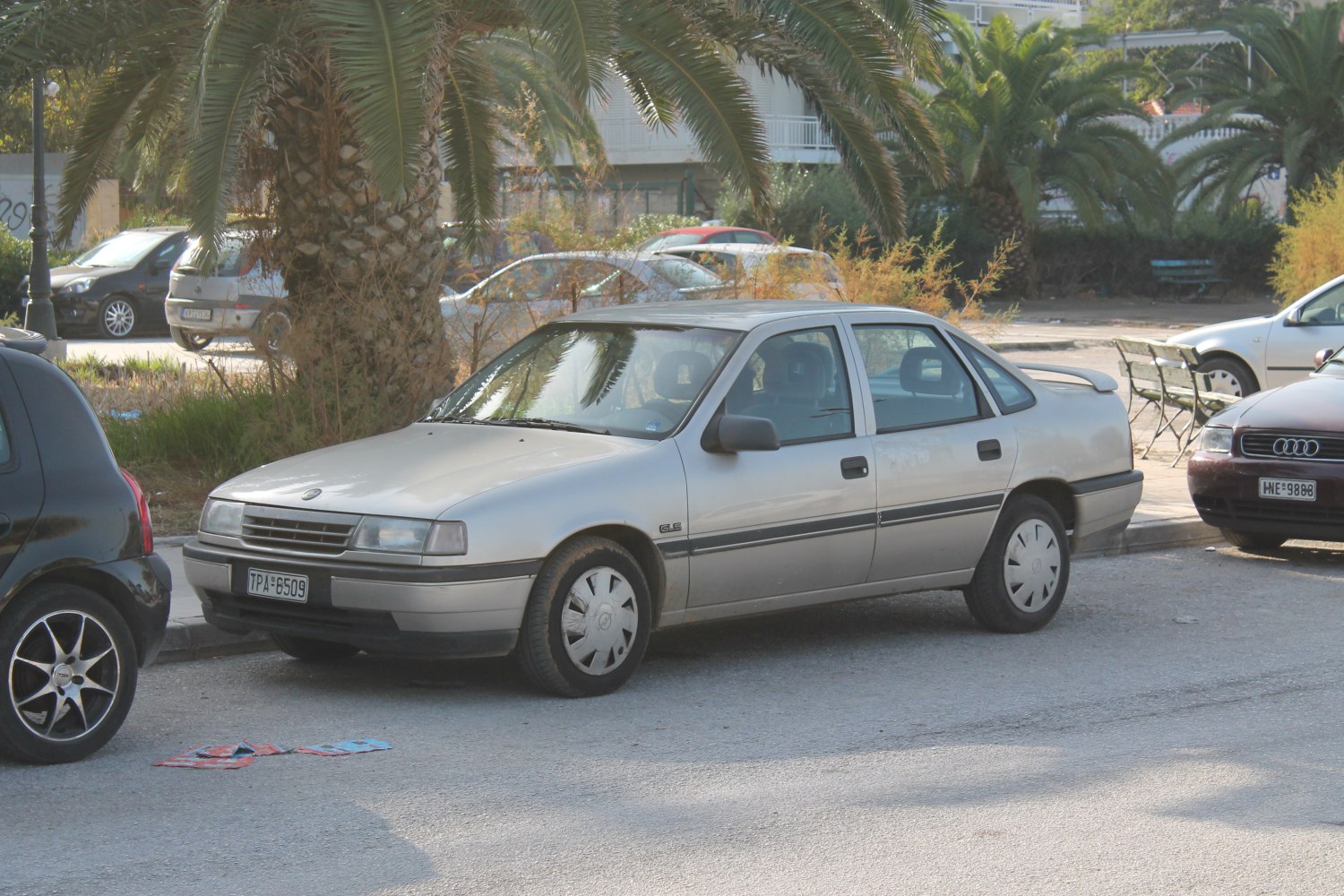 Front side view of a sedan with hubcaps and classic design.