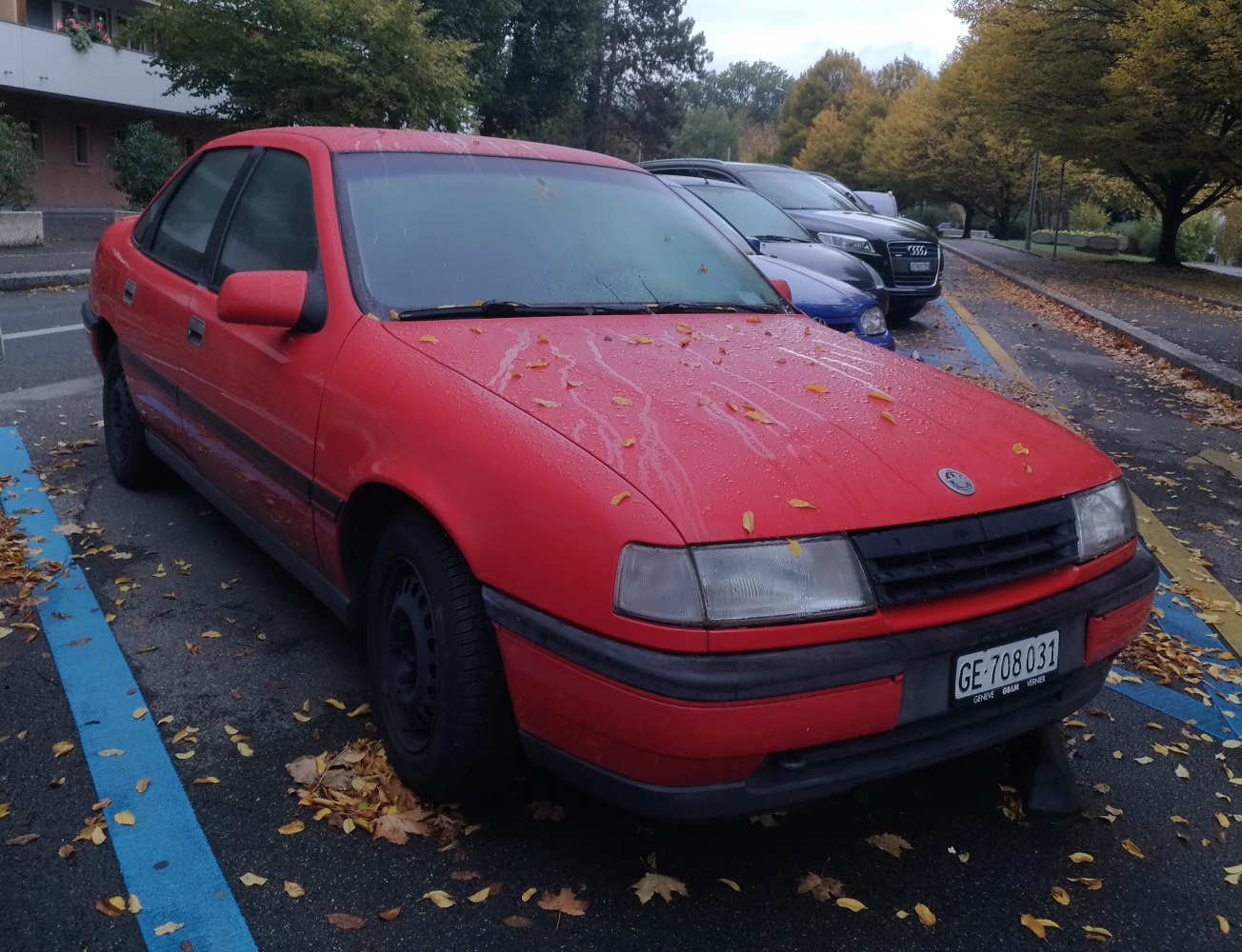 Red sedan with rectangular headlights and black side trim
