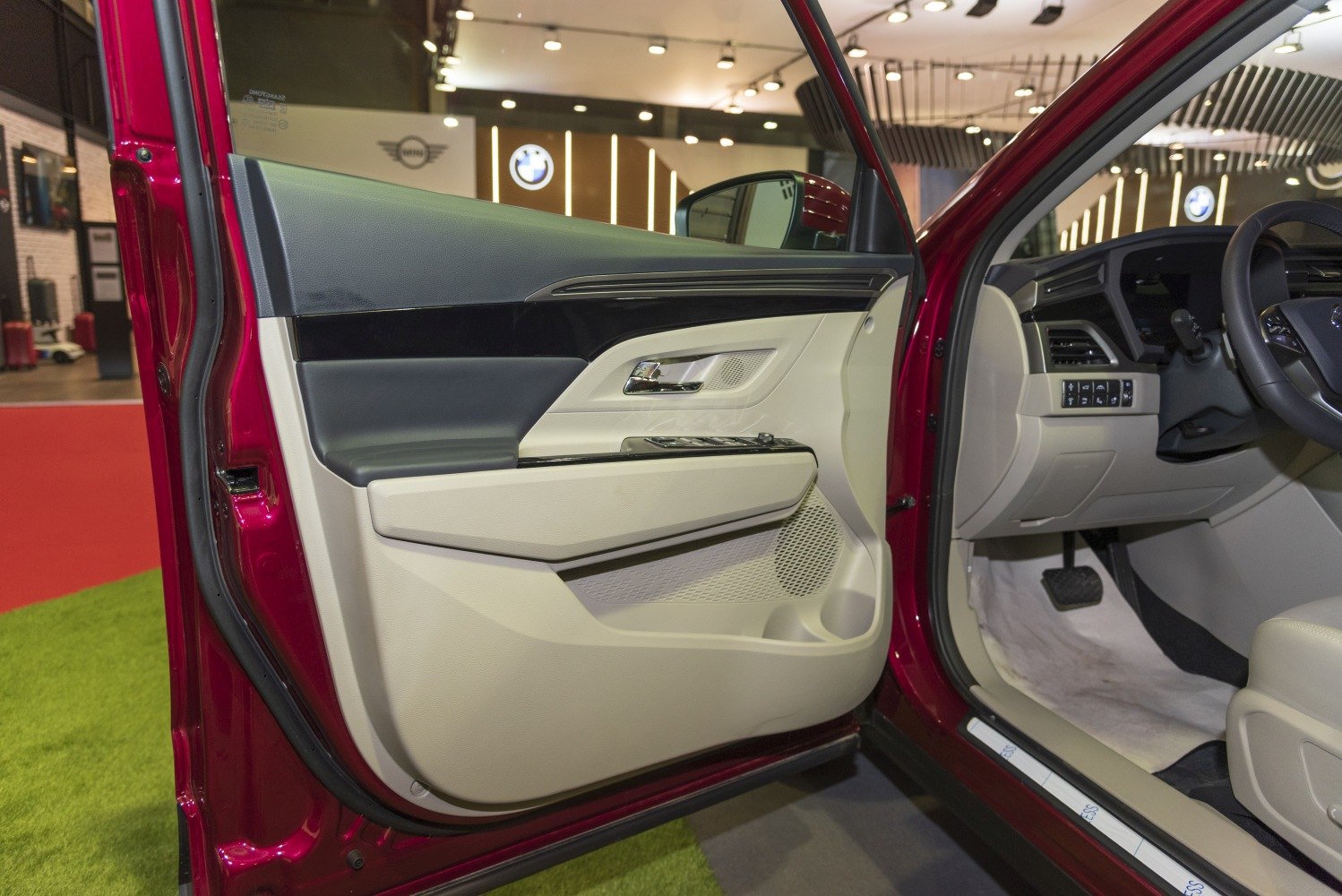 Interior door panel and dashboard with control buttons and beige-black trim