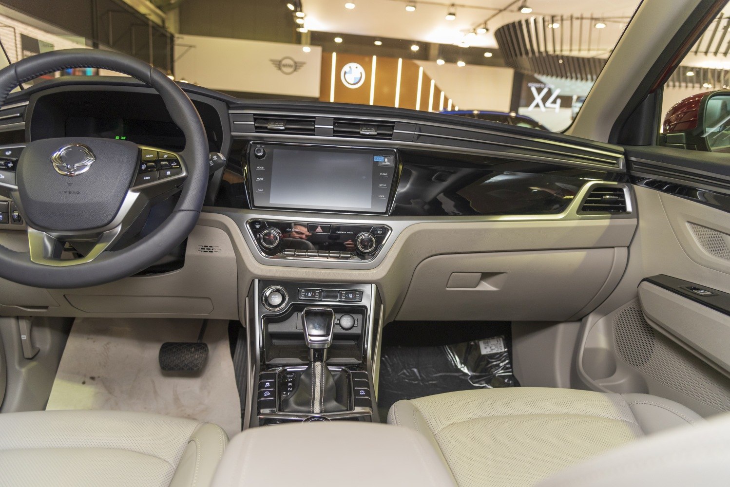 Modern car interior with dashboard, touchscreen, steering wheel, and center console