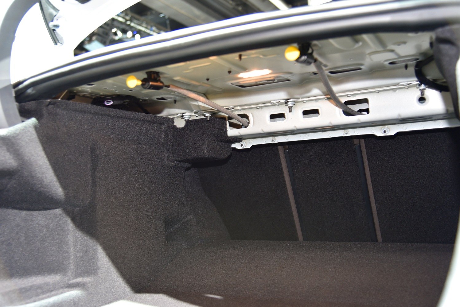 Spacious car trunk interior with visible metal frame and black lining