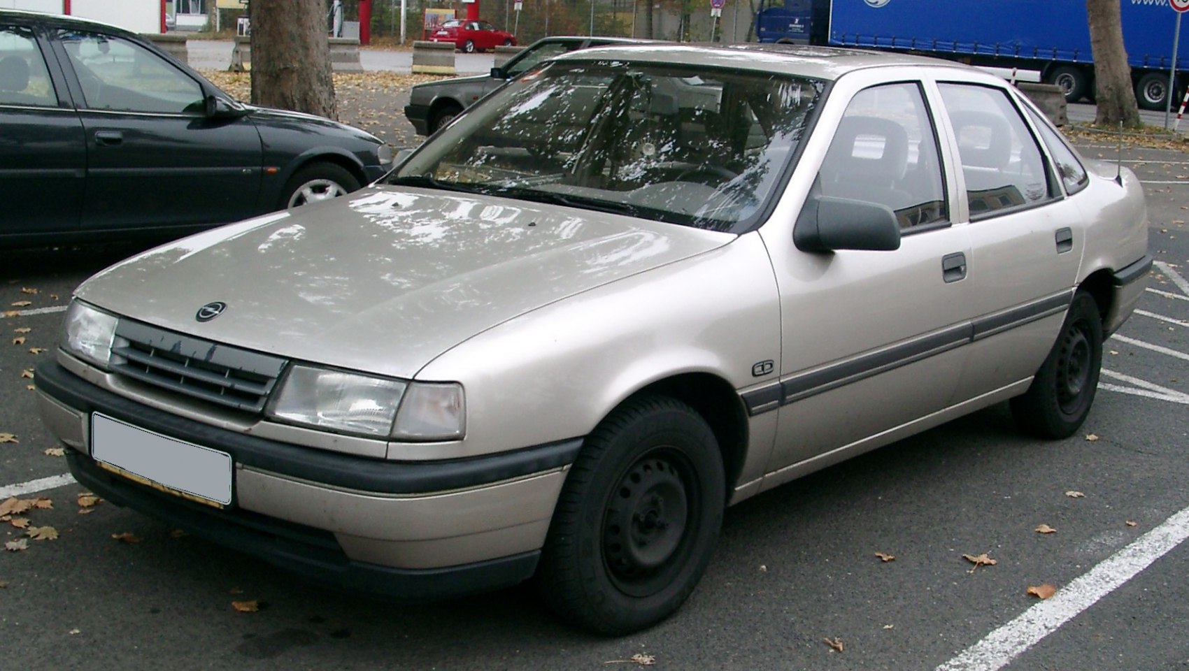 Front and side view of a classic 1988 sedan with four doors and steel rims.